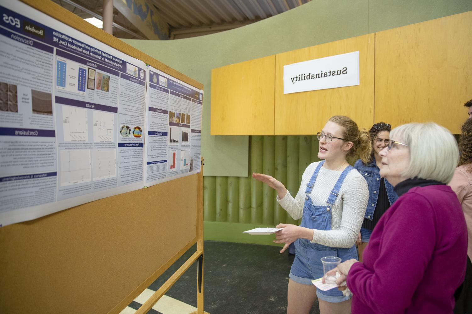 Student showcasing research on Sustainability